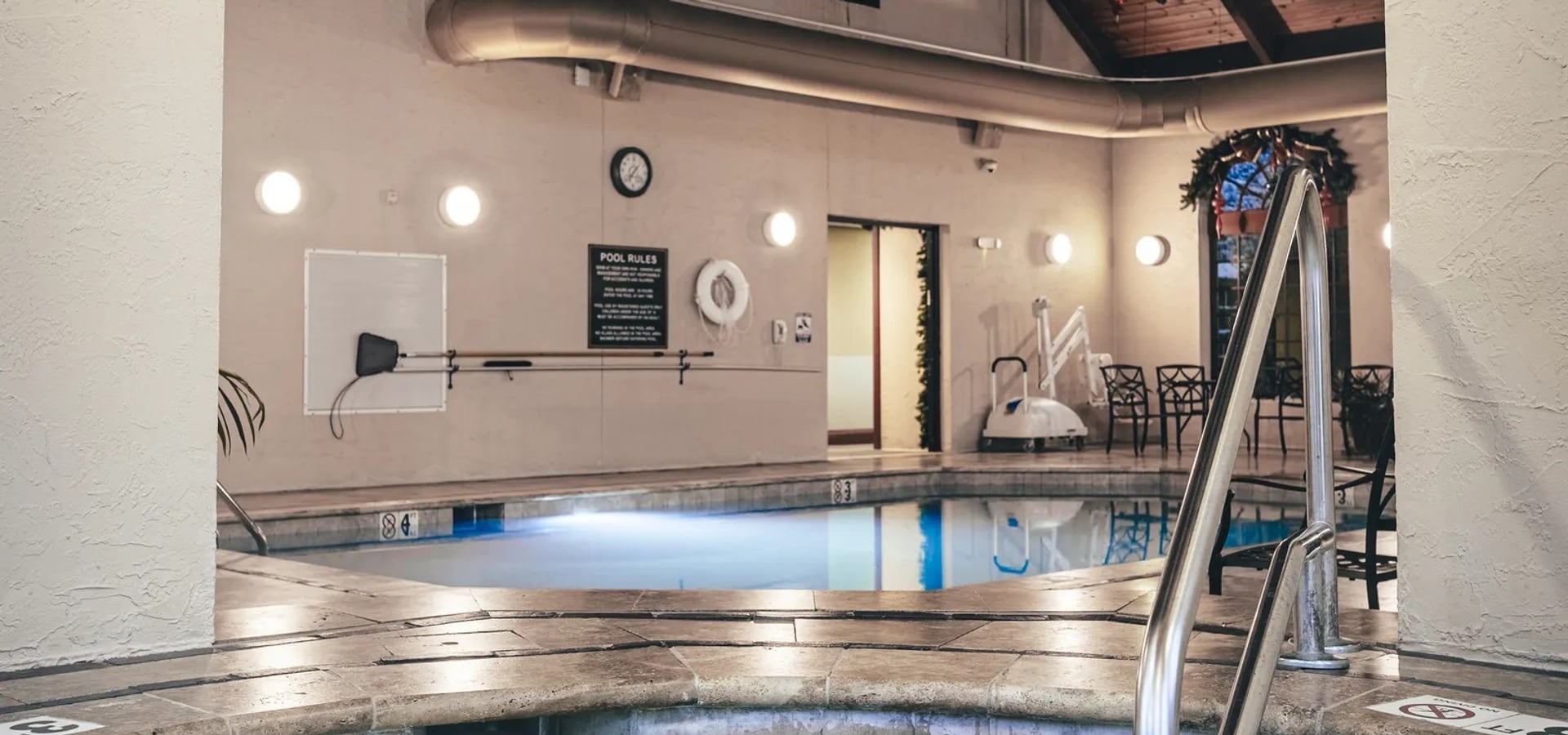 Renovated commercial indoor pool with travertine deck at a Pigeon Forge resort, by Morales Outdoor Living
