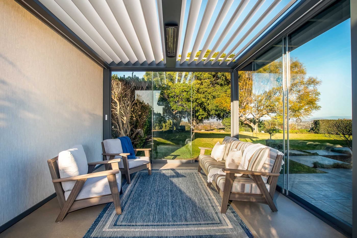 Outdoor Elements Solace louvered aluminum roof over an outdoor kitchen and dining area