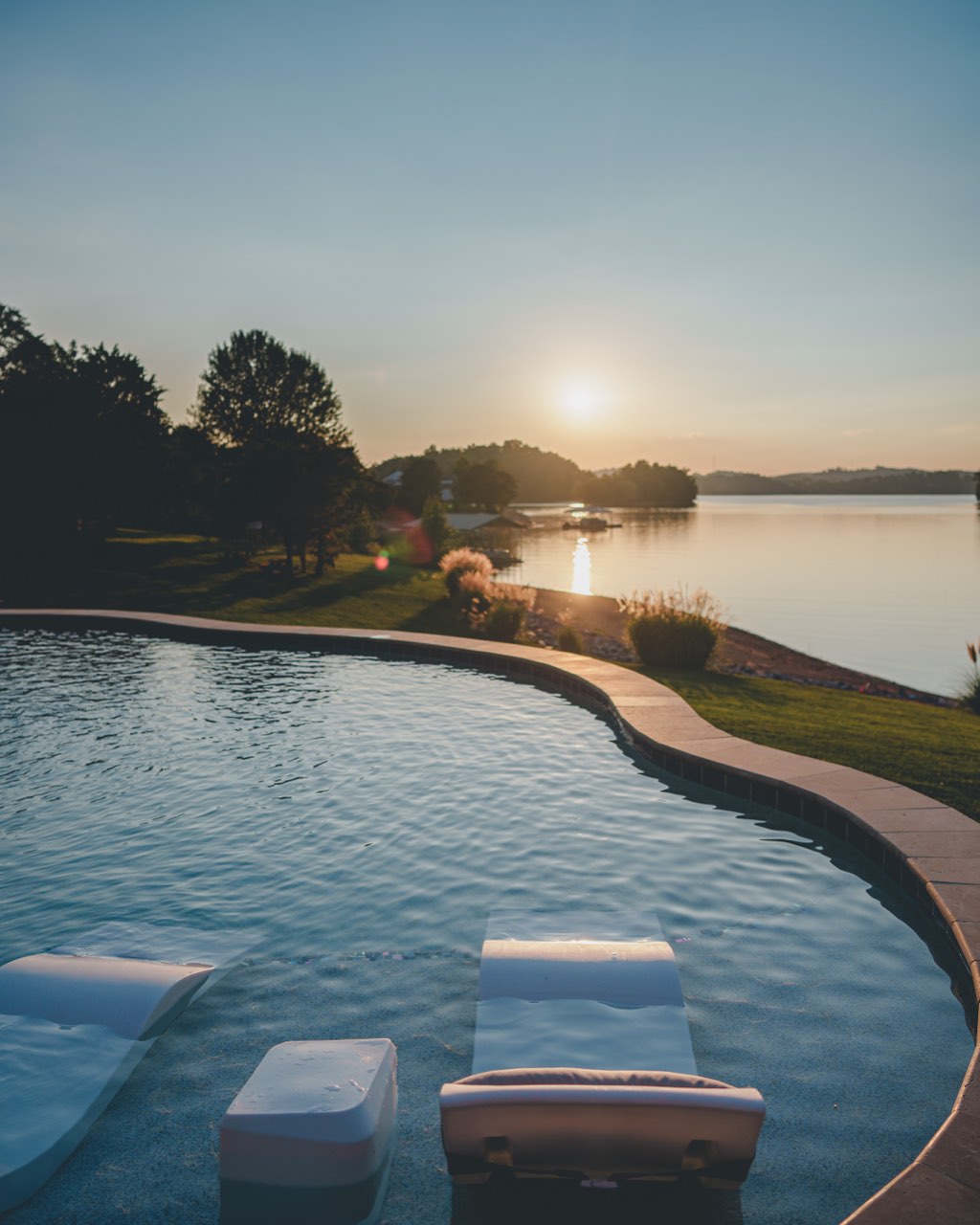 Tanning Ledge Loungers Facing Lake at Sunset