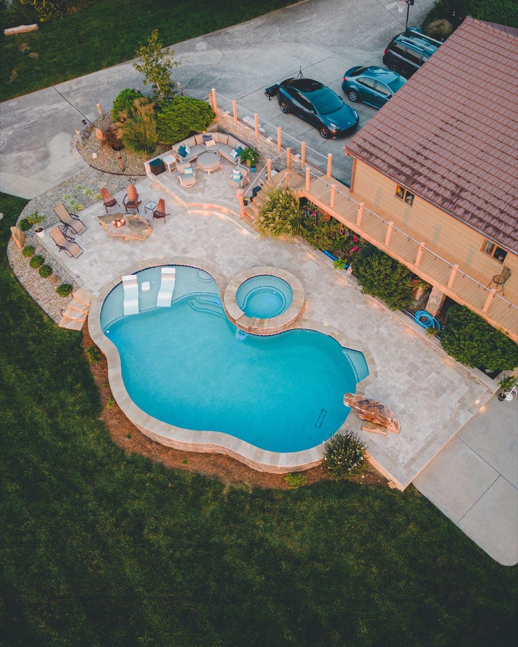 Aerial Freeform Pool, Spa & Travertine Patio at Dusk