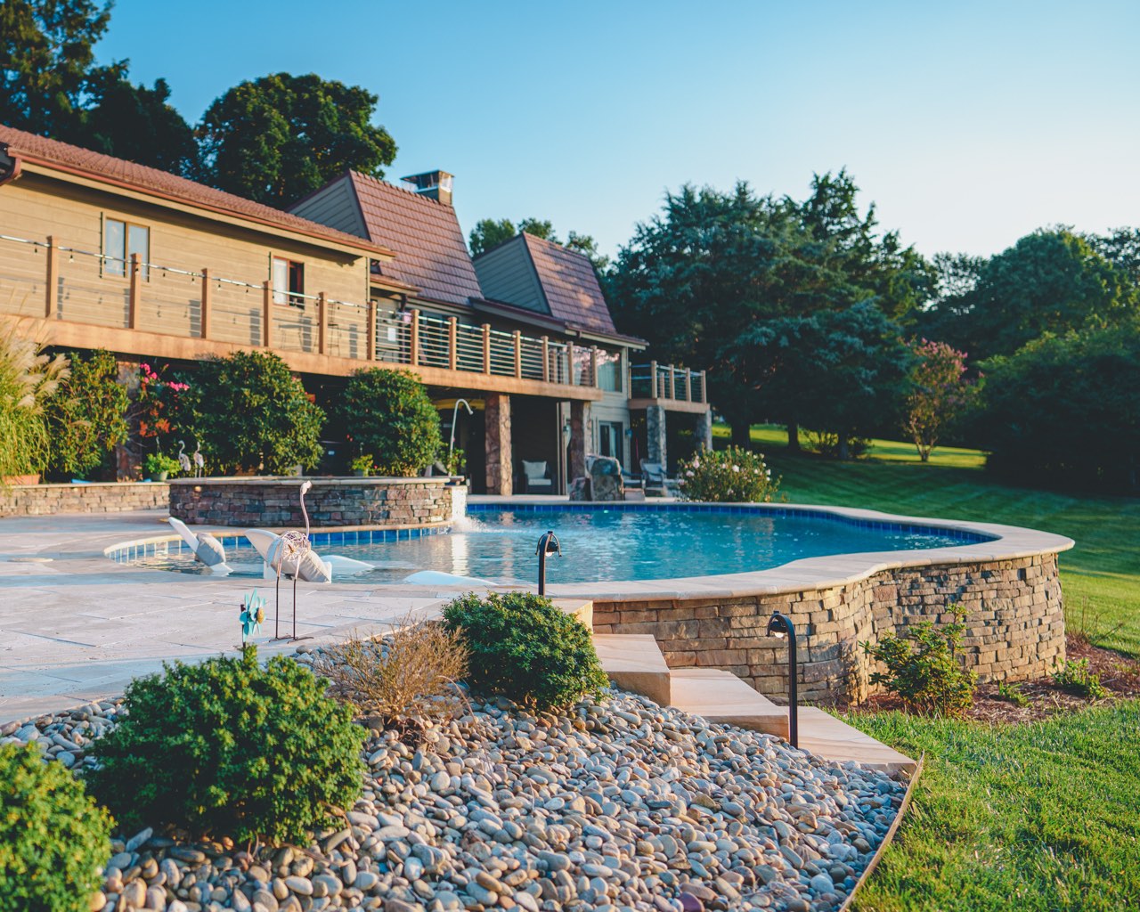 Raised Stone Pool Wall With River Rock Bed