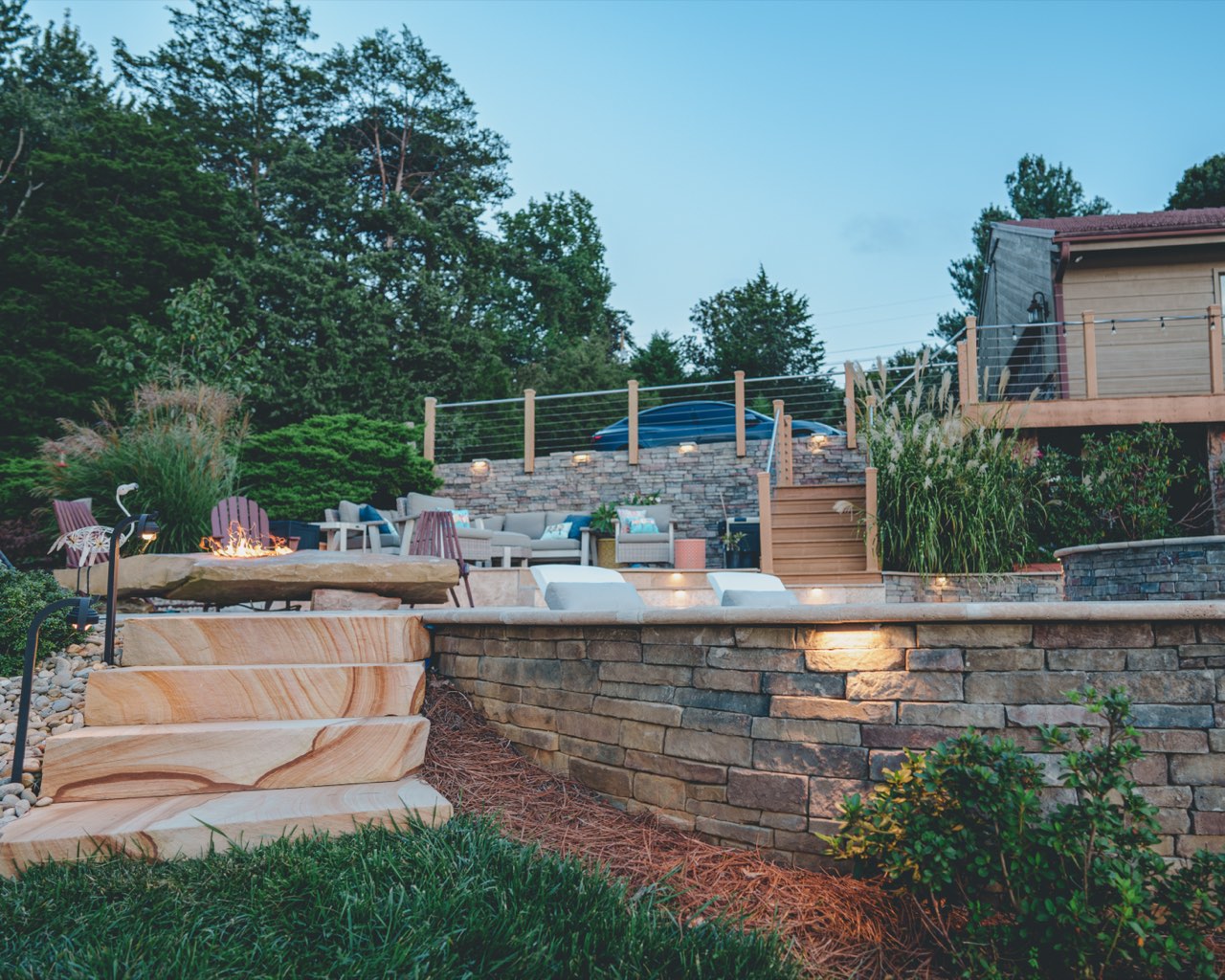 Illuminated Stacked Stone Retaining Wall at Twilight