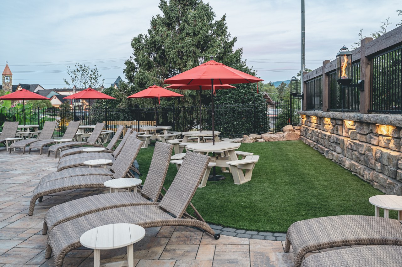Paver Patio With Turf Lawn And Stacked Stone Lantern Wall