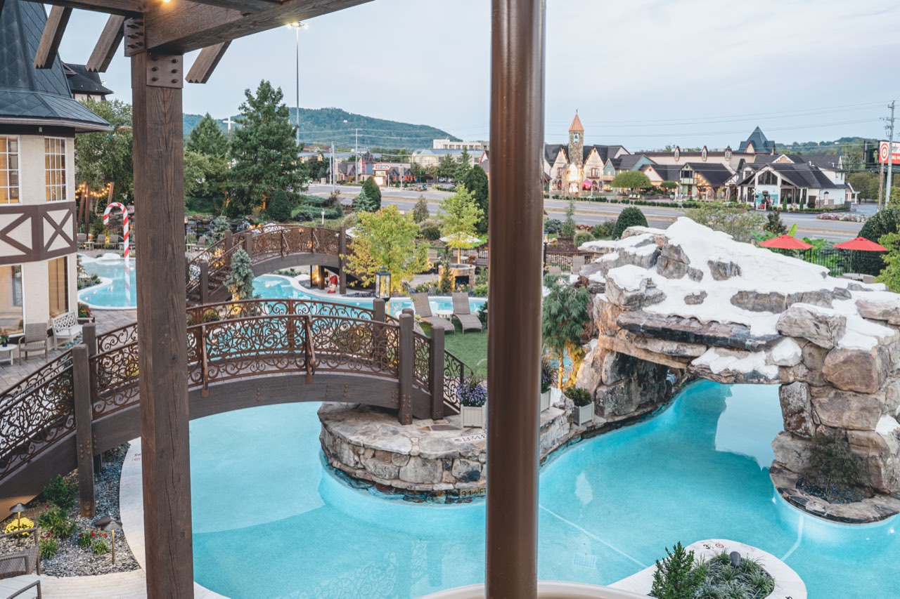 Ornate Bridge And Stacked Stone Grotto Over Paver Deck