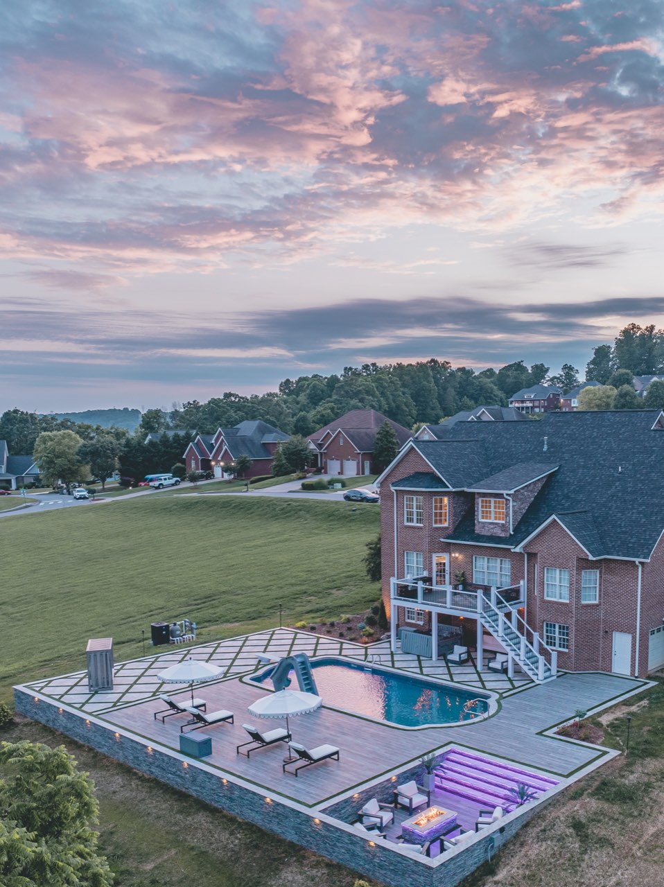 Aerial Twilight Pool, Sunken Fire Lounge Under Pink Sky