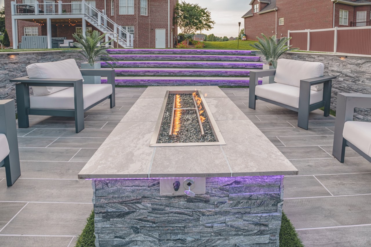 Linear Stone Fire Table, LED Lit Steps At Dusk