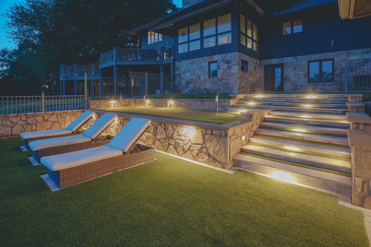 Illuminated Travertine Steps & Stone Retaining Walls At Dusk
