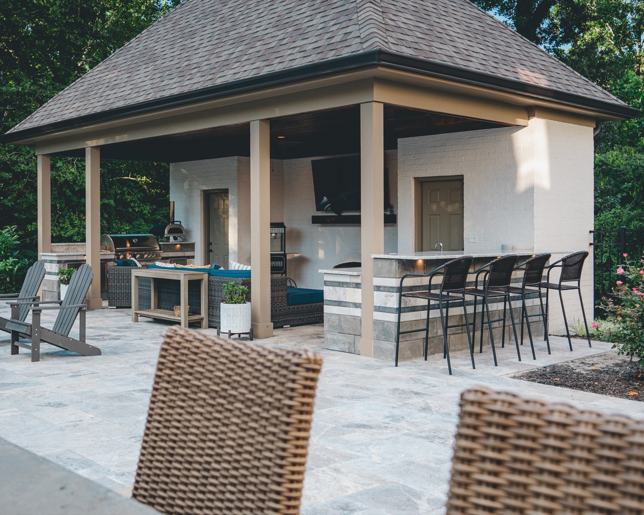 Pavilion With Outdoor Kitchen and Stone Bar at Dusk