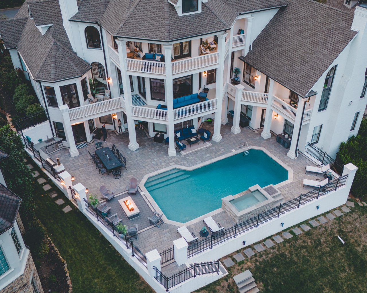 Aerial Gunite Pool, Raised Spa & Paver Deck at Twilight