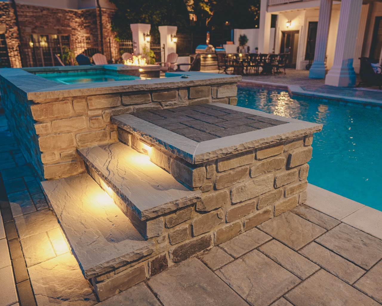 Raised Stone Spa, Fire Pit & Illuminated Pool at Twilight