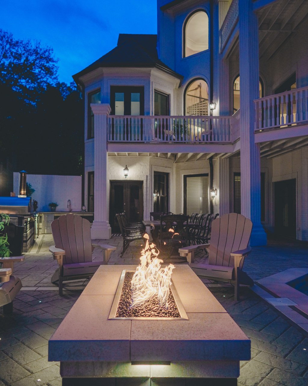 Stamped Patio Fire Pit Below Estate Balconies at Blue Hour