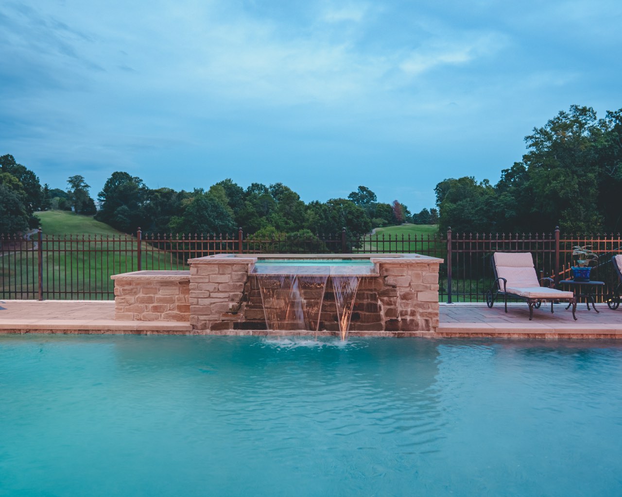 Stone Spa Spillway Over Gunite Pool With Open Views