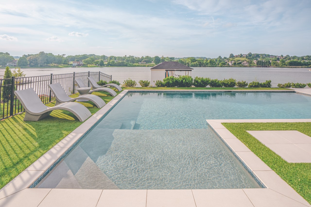Infinity-Edge Gunite Pool With Tanning Ledge Over Lake