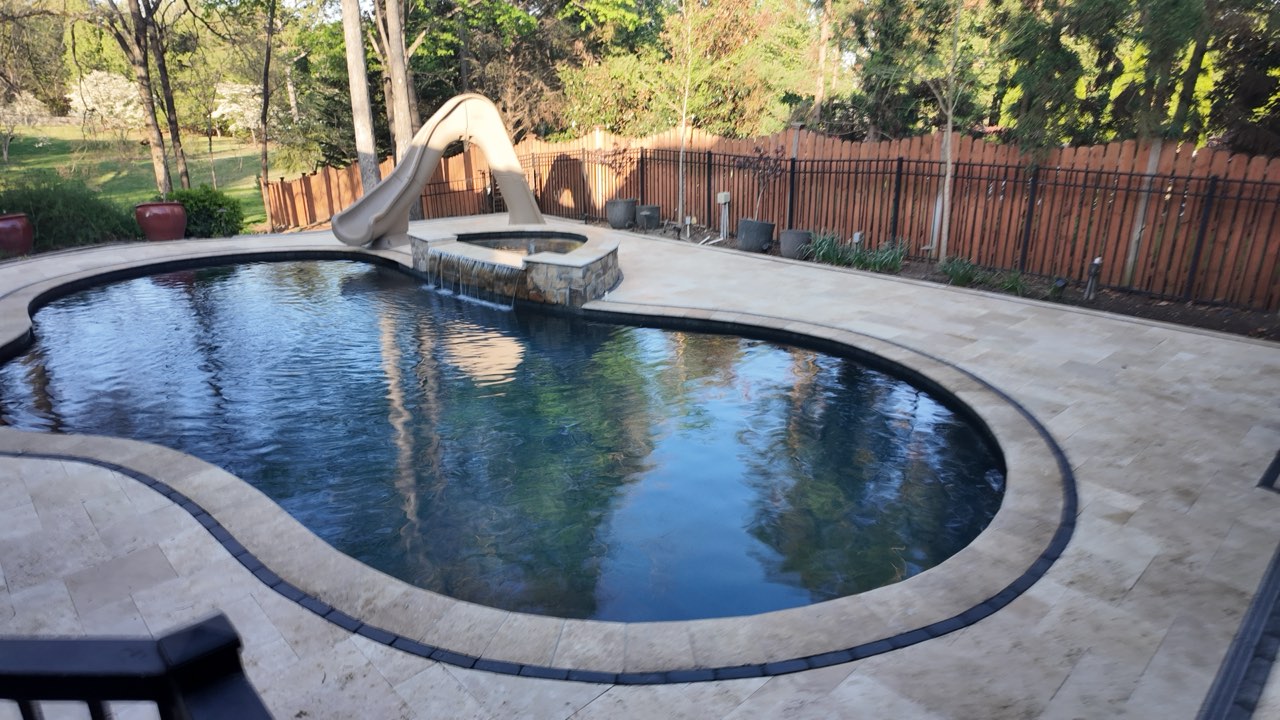 Freeform Gunite Pool, Raised Stone Spa, Slide & Travertine Deck at Golden Hour