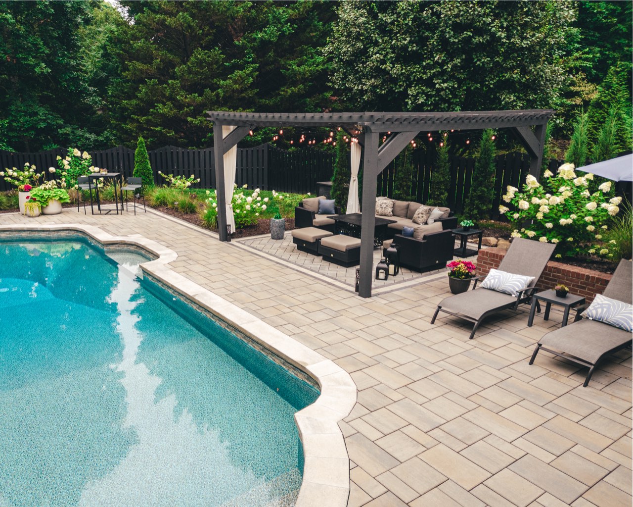 Aerial Gunite Pool With Pergola And Expansive Paver Deck