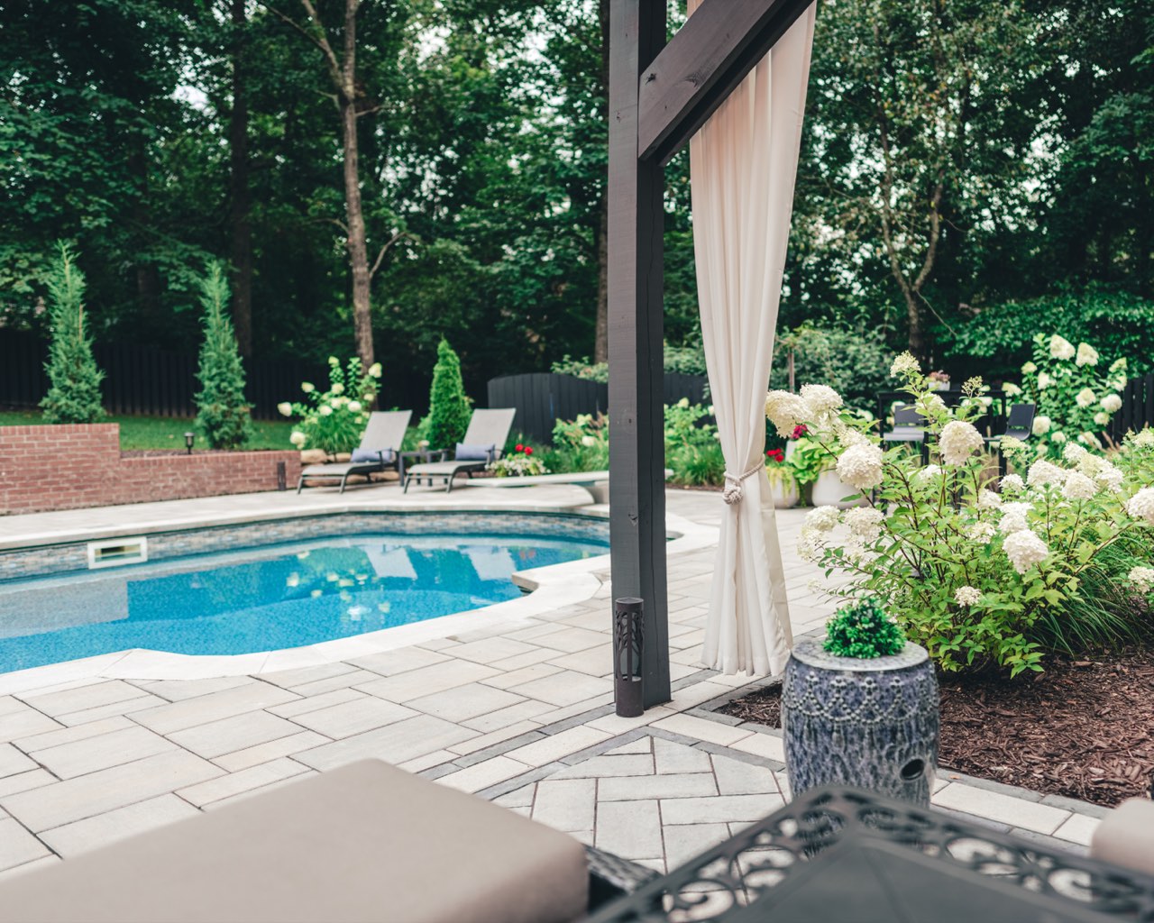 Gunite Pool Through Curtained Pergola With Paver Deck
