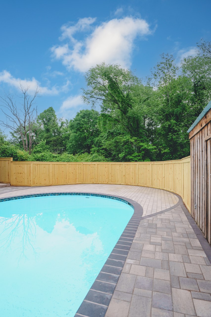 Pool Edge And Paver Coping Beneath Blue Sky