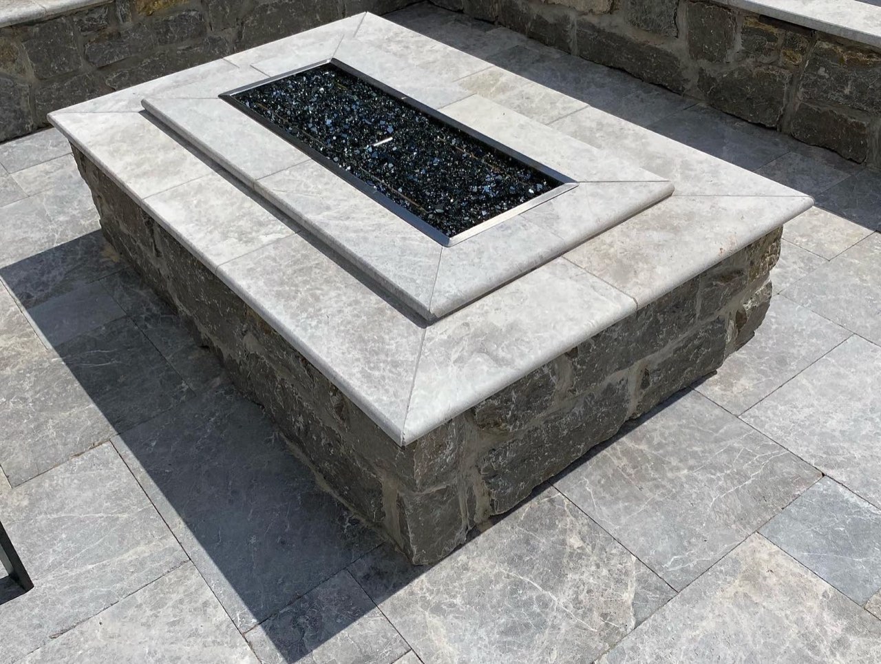 Stacked Stone Gas Fire Pit With Travertine Cap And Fire Glass